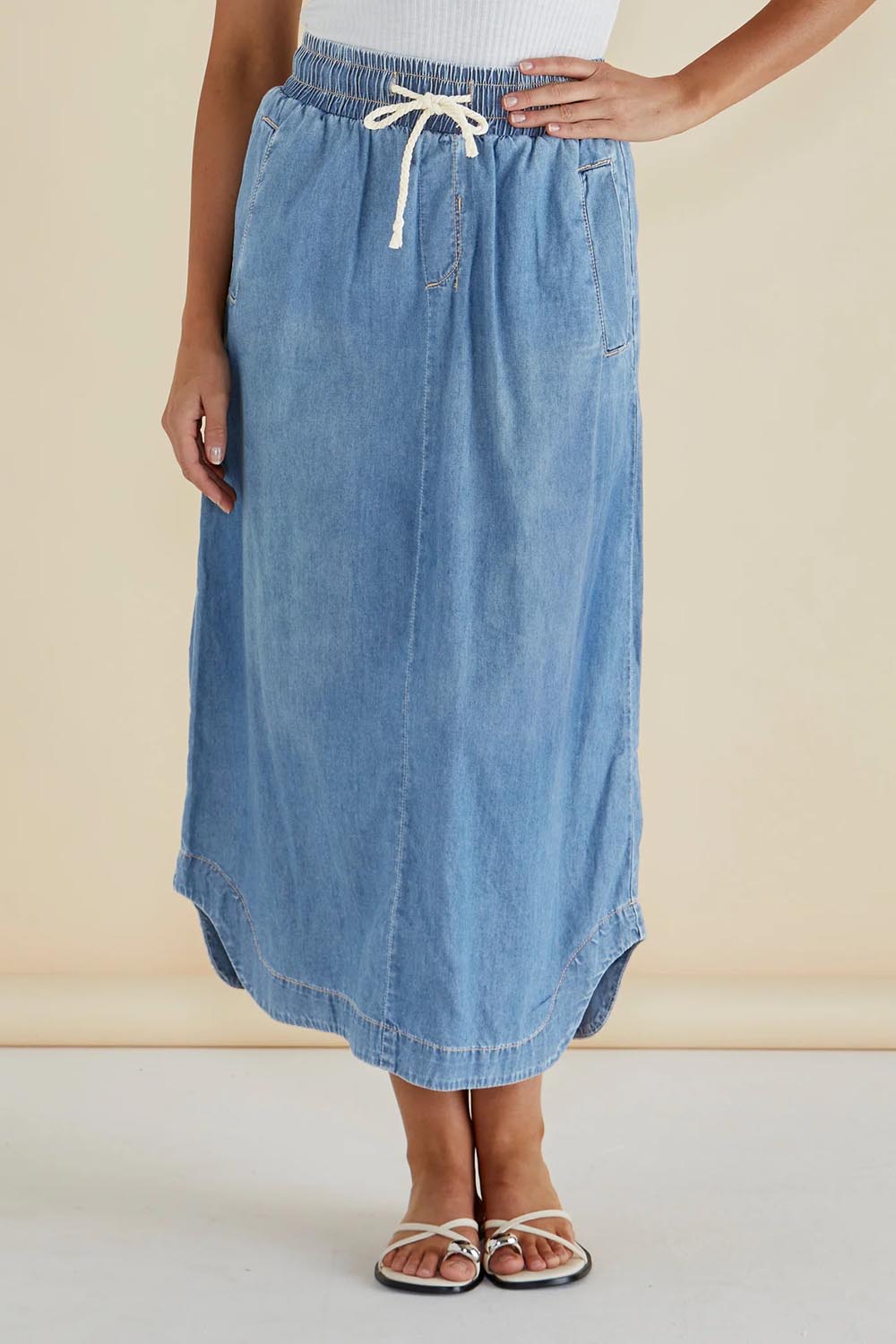 A model wearing the Brunch Denim Skirt in colour Blue (Blue), from the front, cropped image