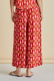A model wearing the Copacabana Relax Pant in colour Sardinia (Red), from the back