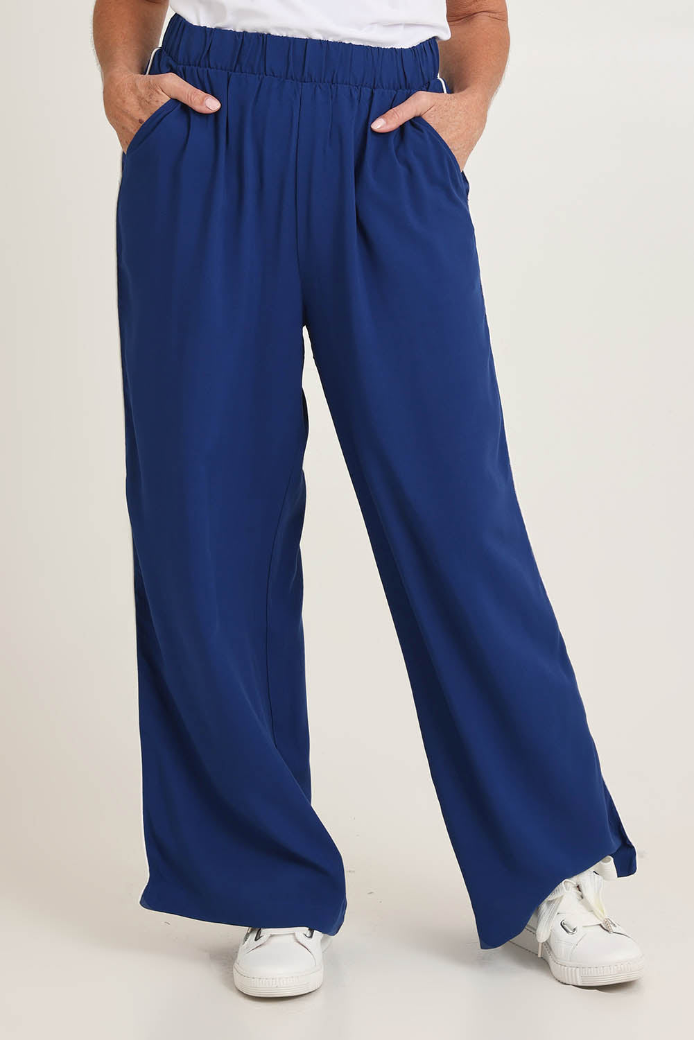 Model Sandy wearing size 10 of the Rio Reef Pant in colour Navy (Blue), from the front, cropped image