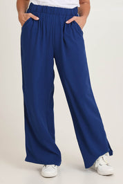Model Sandy wearing size 10 of the Rio Reef Pant in colour Navy (Blue), from the front, cropped image