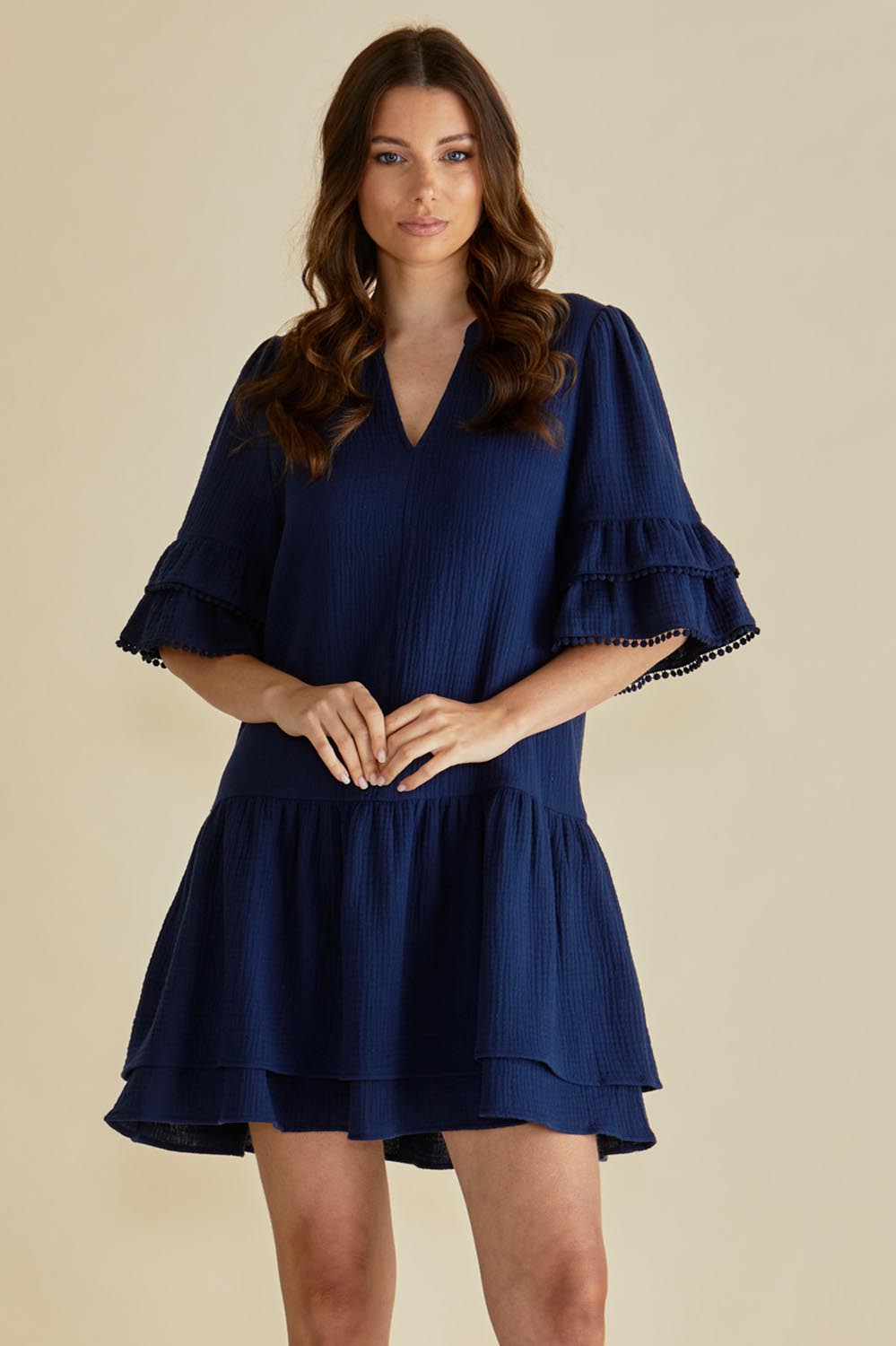 A model wearing the Malibu Cotton Dress in colour Navy (Blue), from the front, cropped image