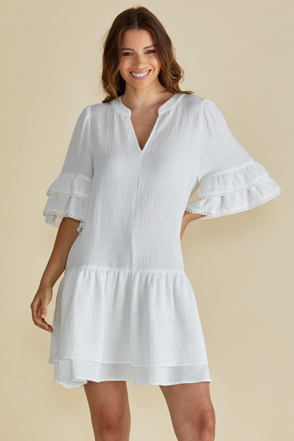 A model wearing the Malibu Cotton Dress in colour White (White), from the front, cropped image