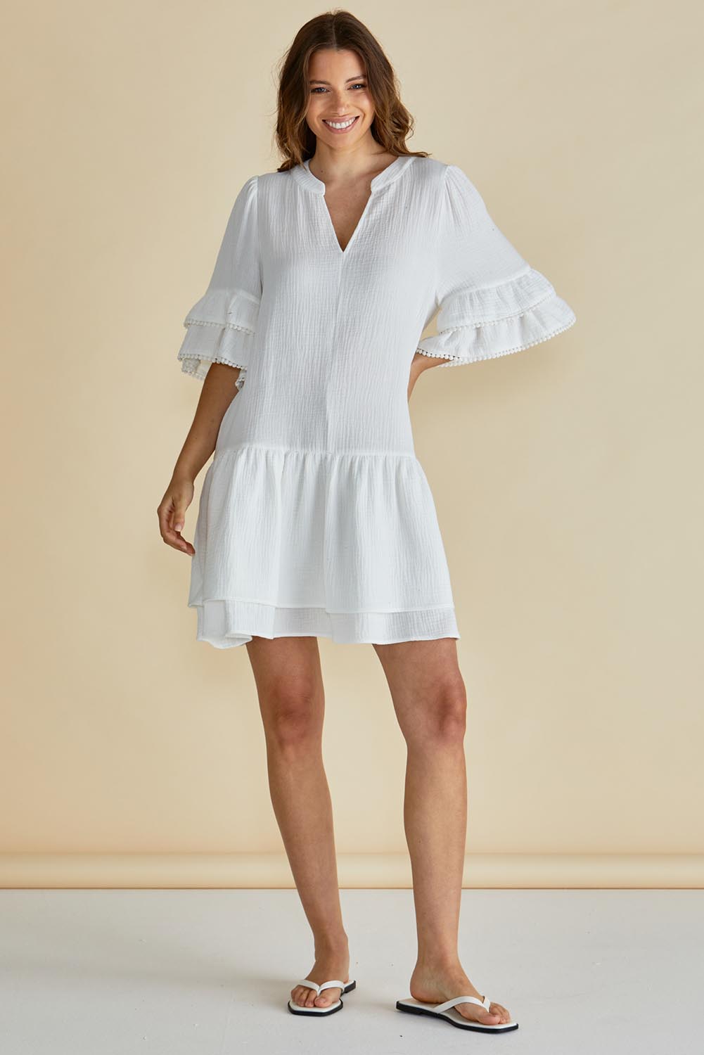 A model wearing the Malibu Cotton Dress in colour White (White), from the front, showing the whole outfit