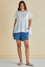 A model wearing the Poppy Cotton Blend Blouse in colour White (White), from the front, showing the whole outfit