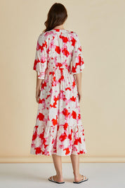 A model wearing the Moxie Dress in colour Redfloral (Red), from the back