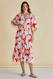 A model wearing the Moxie Dress in colour Redfloral (Red), from the front, showing the whole outfit