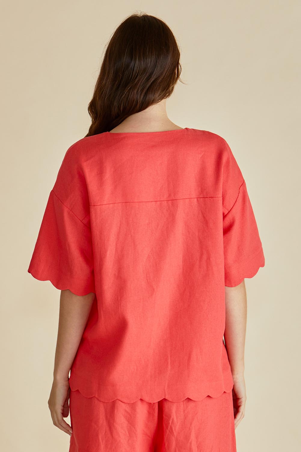 A model wearing the Scarlett Shirt in colour Red (Red), from the back