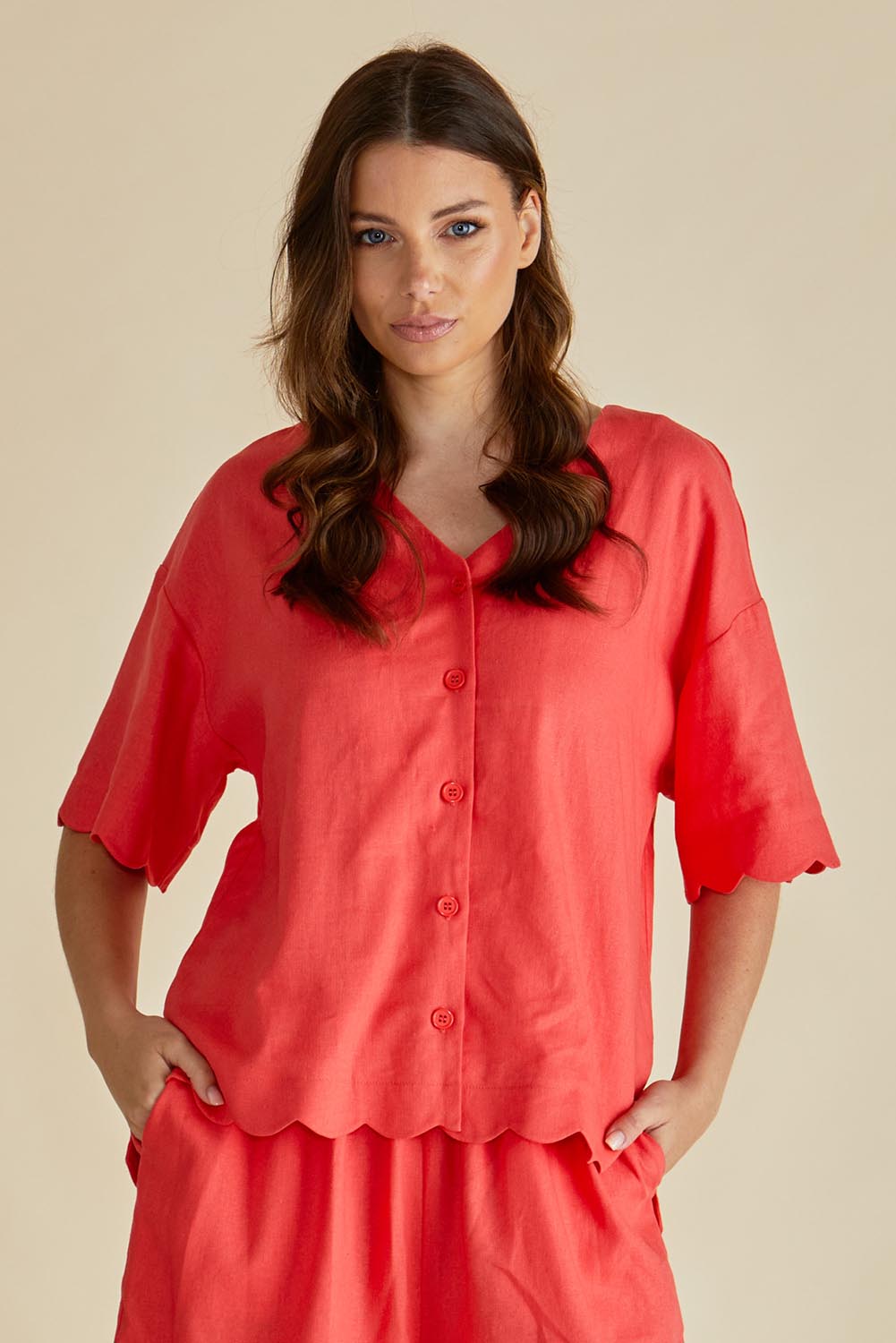 A model wearing the Scarlett Shirt in colour Red (Red), from the front, cropped image