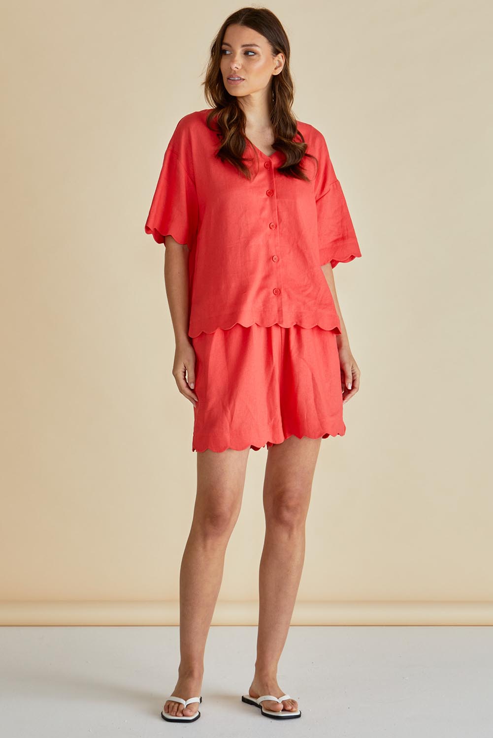 A model wearing the Scarlett Shirt in colour Red (Red), from the front, showing the whole outfit