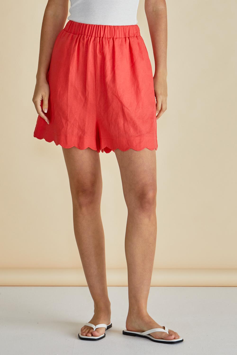 A model wearing the Seraphina Short in colour Red (Red), from the front, cropped image