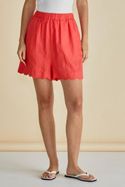 A model wearing the Seraphina Short in colour Red (Red), from the front, cropped image