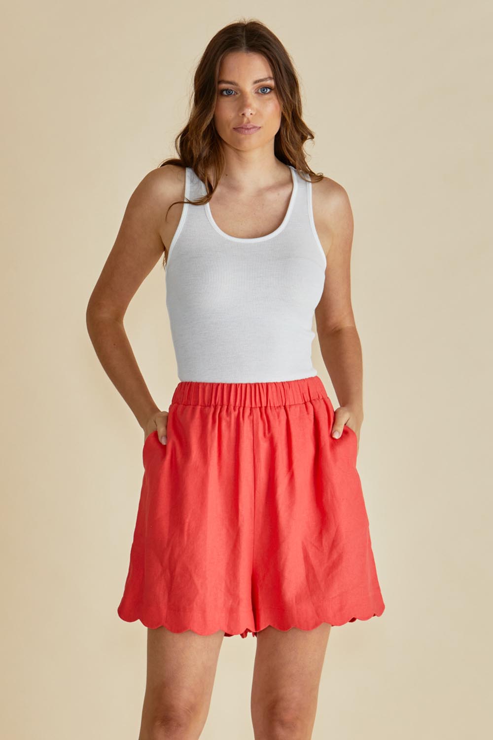 A model wearing the Seraphina Short in colour Red (Red), from the front, cropped image