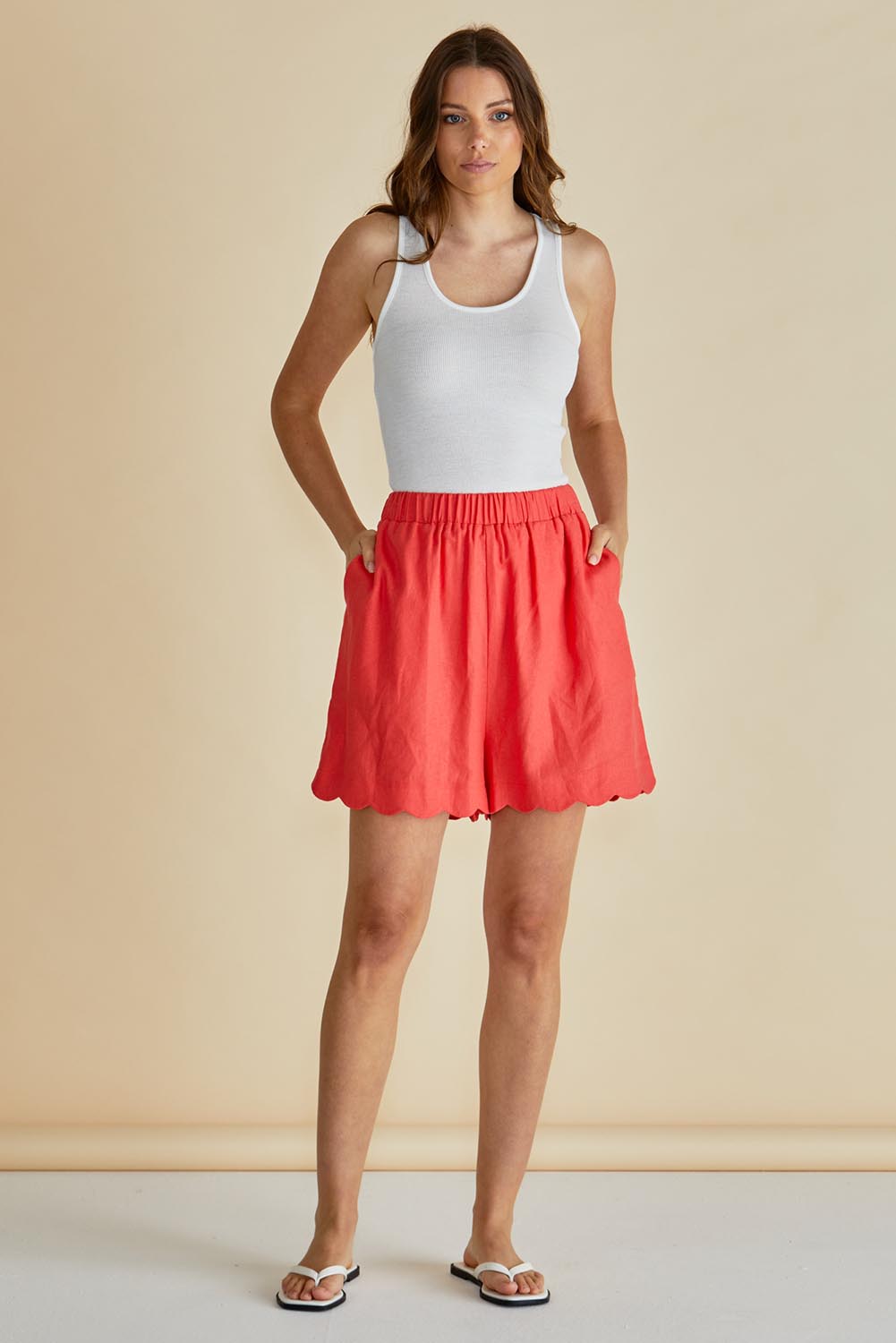 A model wearing the Seraphina Short in colour Red (Red), from the front, showing the whole outfit