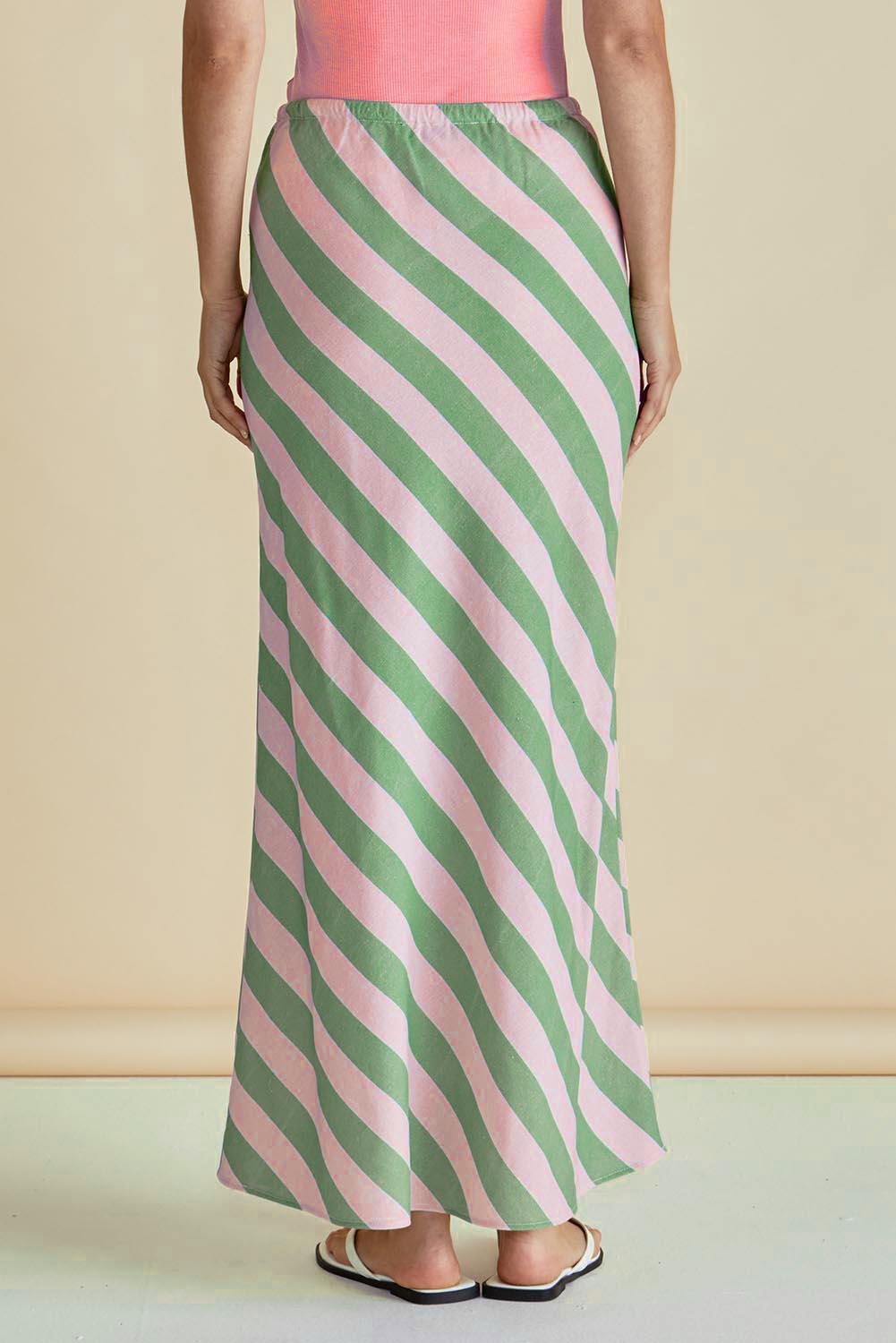 A model wearing the Brooke Bias Skirt in colour Greenpink (Green), from the back