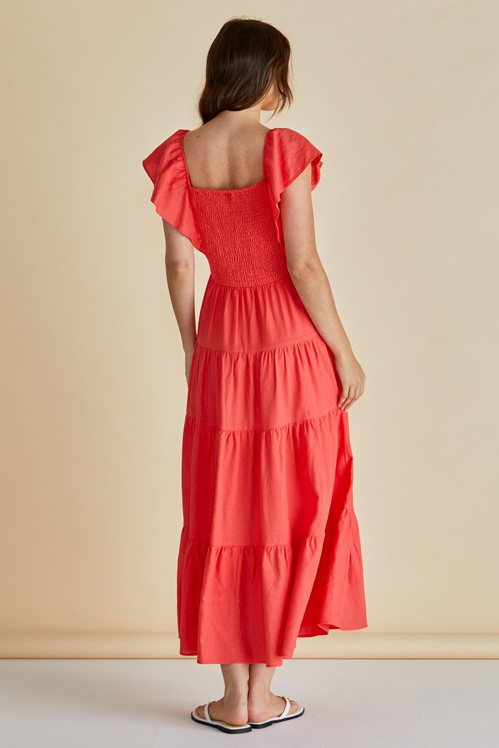 A model wearing the Sadie Dress in colour Red (Red), from the back
