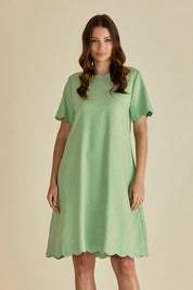 A model wearing the Dawn Shift Dress in colour Green (Green), from the front, cropped image