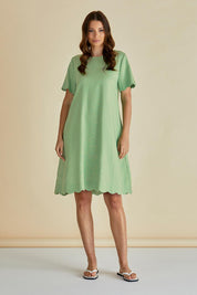 A model wearing the Dawn Shift Dress in colour Green (Green), from the front, showing the whole outfit