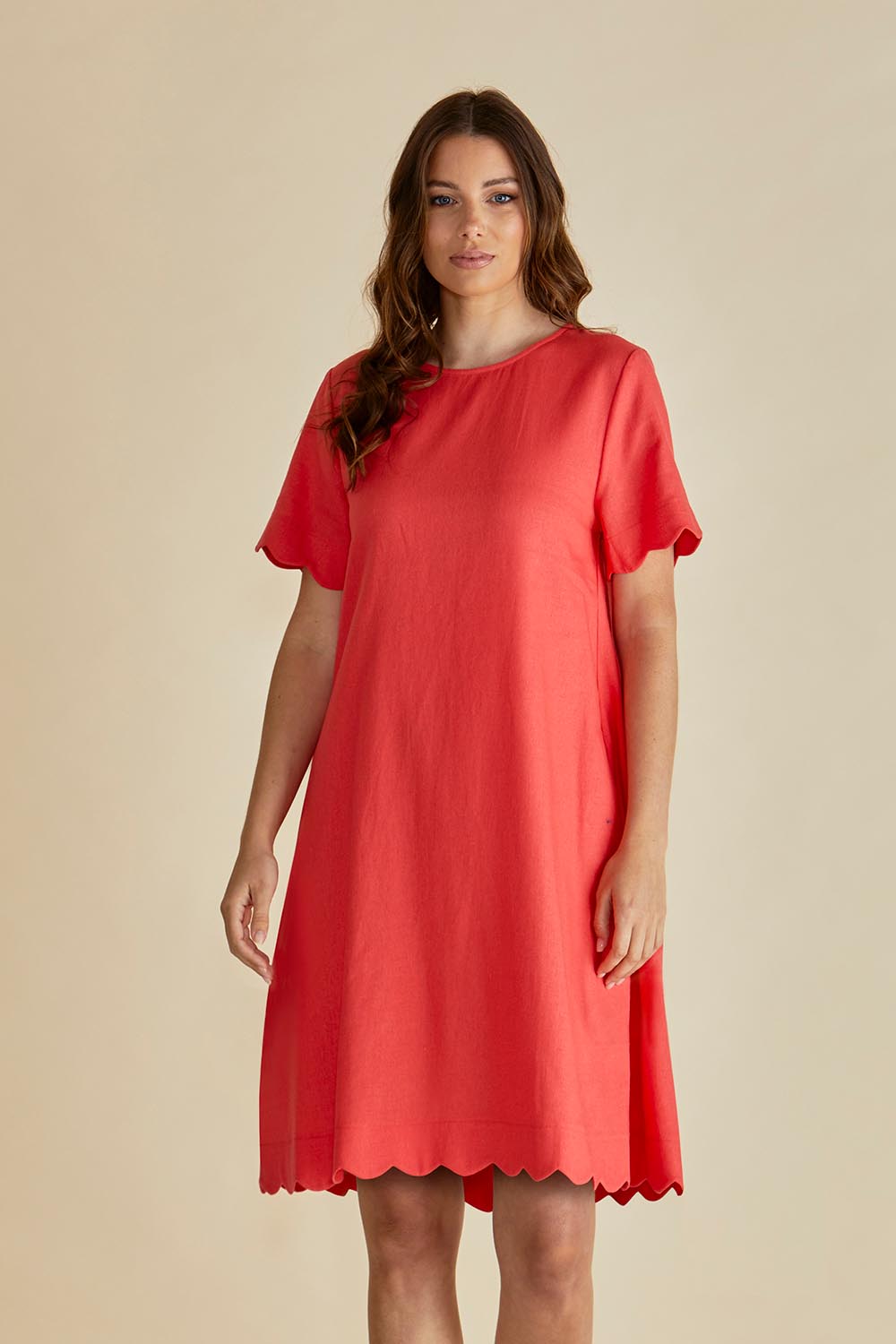 A model wearing the Dawn Shift Dress in colour Red (Red), from the front, cropped image