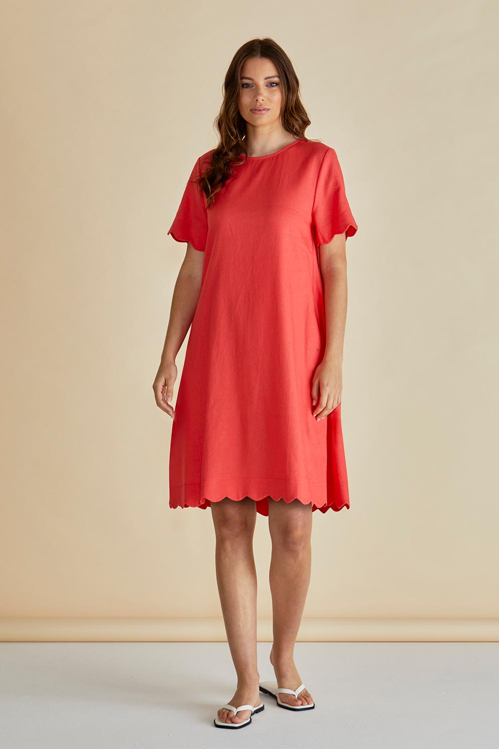 A model wearing the Dawn Shift Dress in colour Red (Red), from the front, showing the whole outfit
