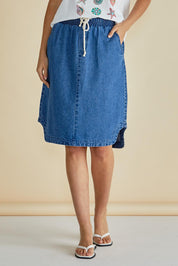 A model wearing the Dara Denim Skirt in colour Blue (Blue), from the front, cropped image