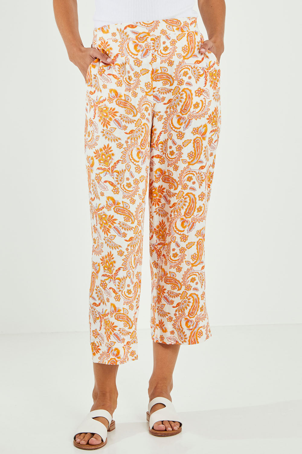 Model Alice wearing size 10 of the Parker Pant in colour Paisley (White), from the front, cropped image