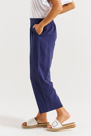A model wearing the Parker Pant in colour Navy (Blue), from the front, cropped image