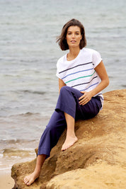A model wearing the Parker Pant in colour Navy (Blue), from the front, showing the whole outfit