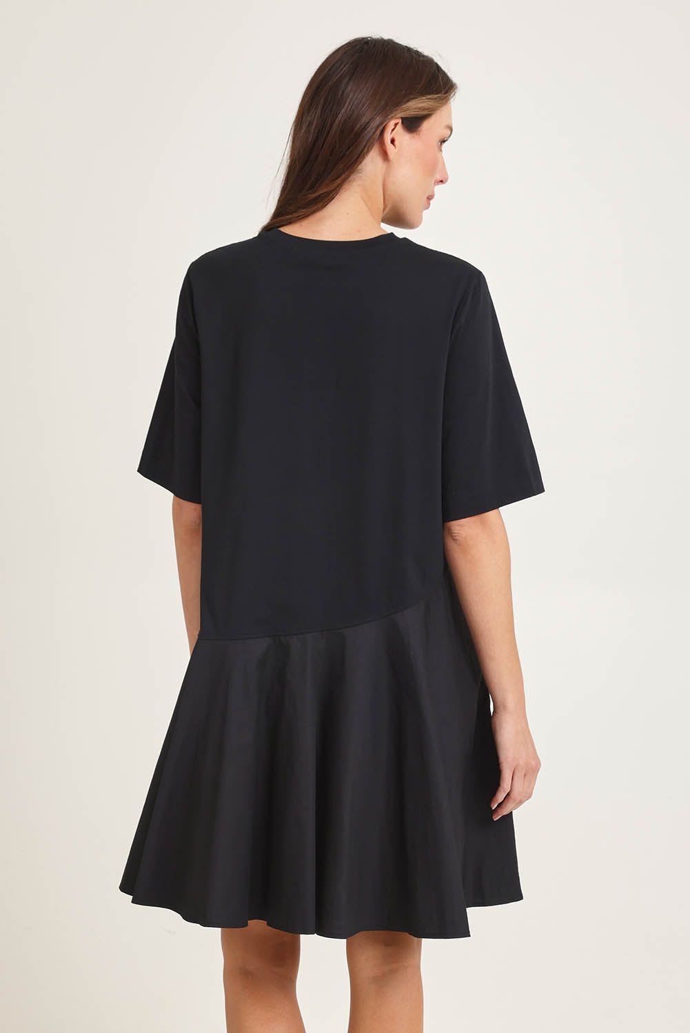 Model Madeline wearing size 10 of the Cassidy Cotton Dress in colour Black (Black), from the back