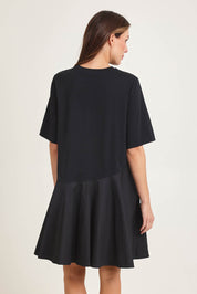 Model Madeline wearing size 10 of the Cassidy Cotton Dress in colour Black (Black), from the back