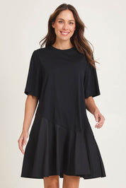 Model Madeline wearing size 10 of the Cassidy Cotton Dress in colour Black (Black), from the front, cropped image