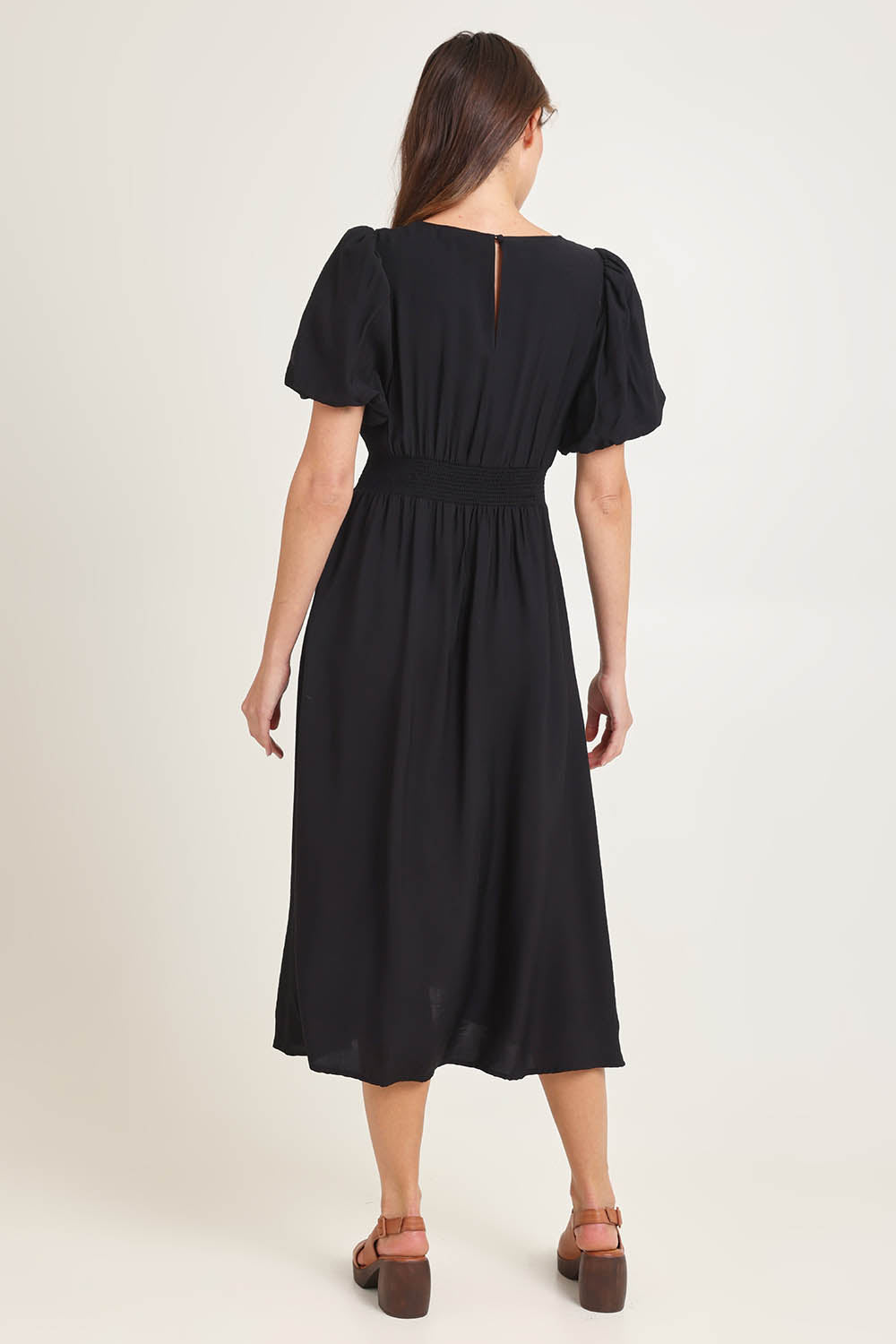 Model Madeline wearing size 10 of the Dahlia Dress in colour Black (Black), from the back