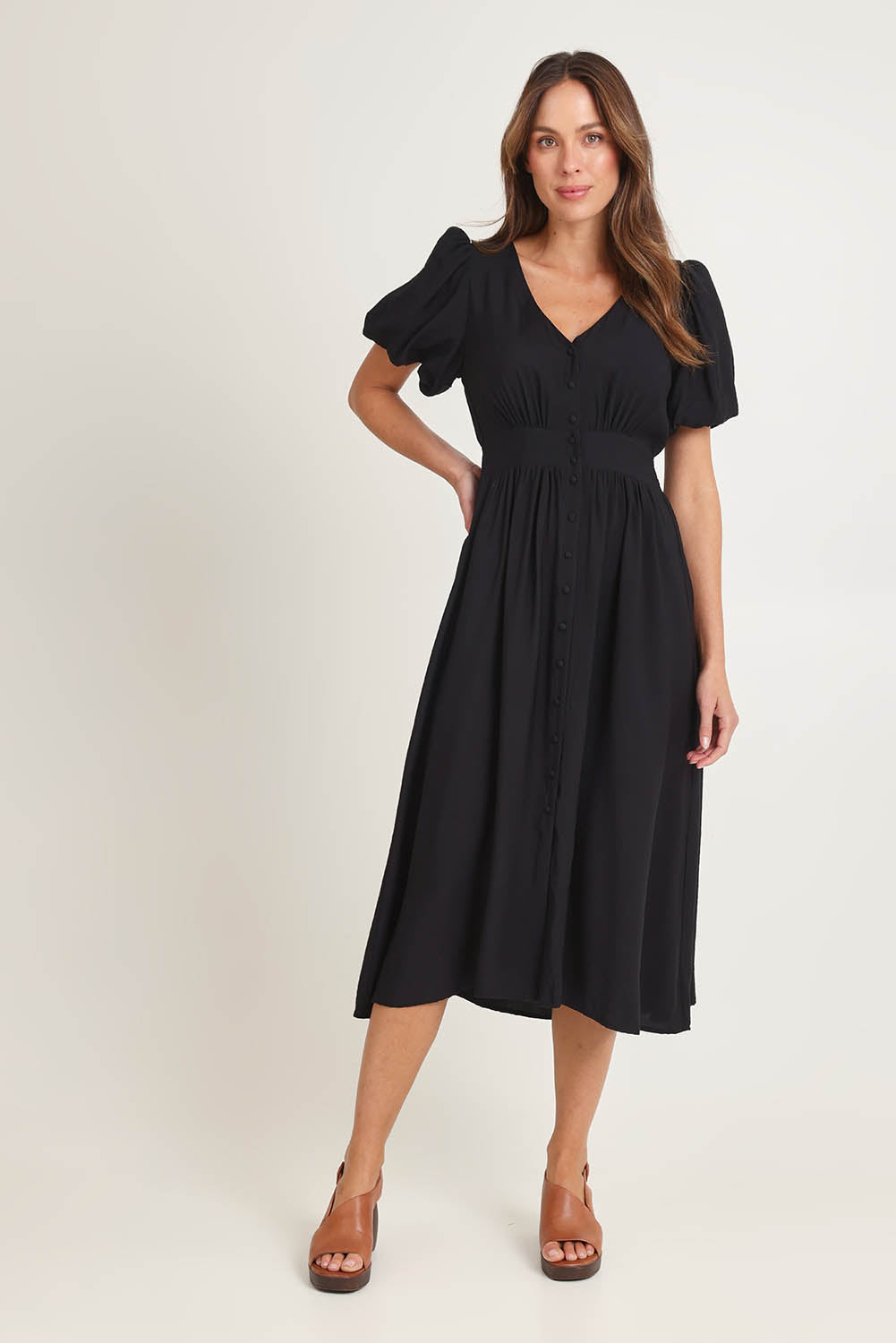 Model Madeline wearing size 10 of the Dahlia Dress in colour Black (Black), from the front, showing the whole outfit