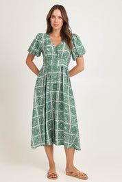 Model Madeline wearing size 10 of the Dahlia Dress in colour Floral (Green), from the front, showing the whole outfit