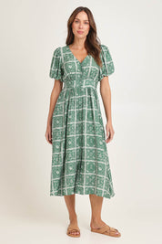 Model Madeline wearing size 10 of the Dahlia Dress in colour Floral (Green), from the front, showing the whole outfit