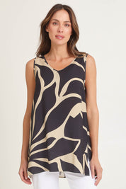 Model Madeline wearing size 10 of the Lana Tunic Tank in colour Floral (Black), from the front, cropped image