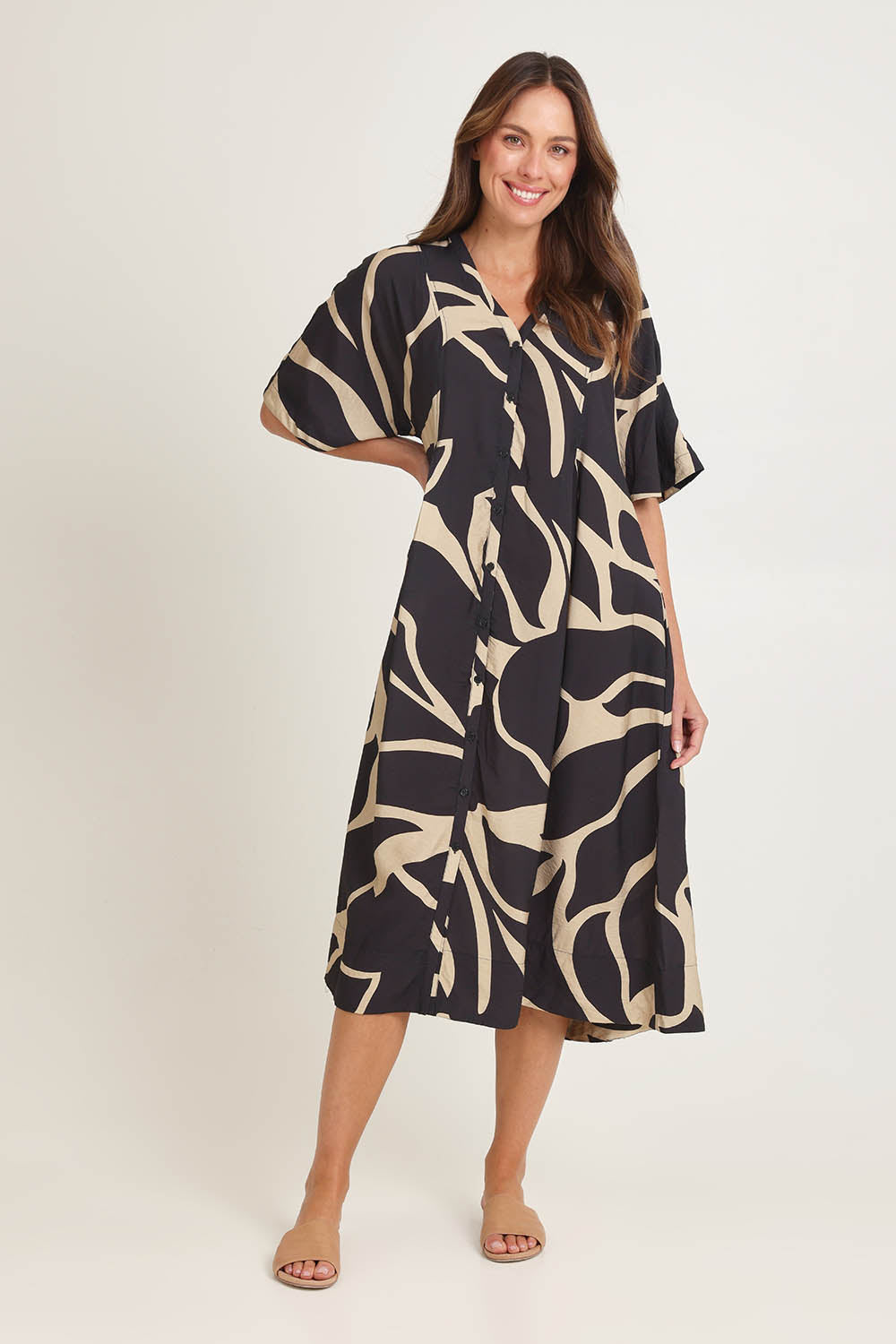 Model Madeline wearing size 10 of the Camille Dress in colour Floral (Black), from the front, showing the whole outfit