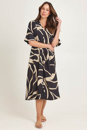 Model Madeline wearing size 10 of the Camille Dress in colour Floral (Black), from the front, showing the whole outfit