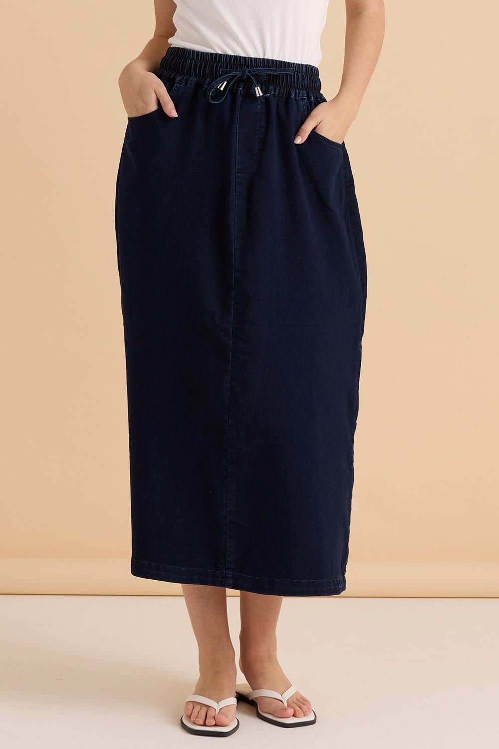 A model wearing the Denim Maxi Jogger Skirt in colour Darkblue (Blue), from the front, cropped image