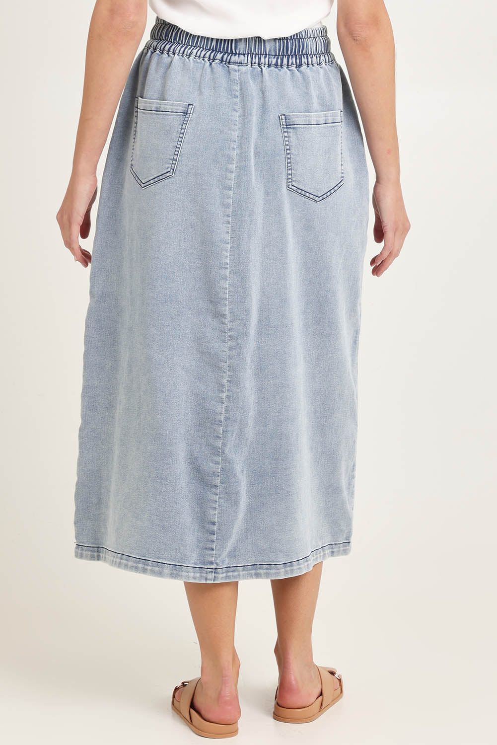 Model Madeline wearing size 10 of the Denim Maxi Jogger Skirt in colour Lightblue (Blue), from the back