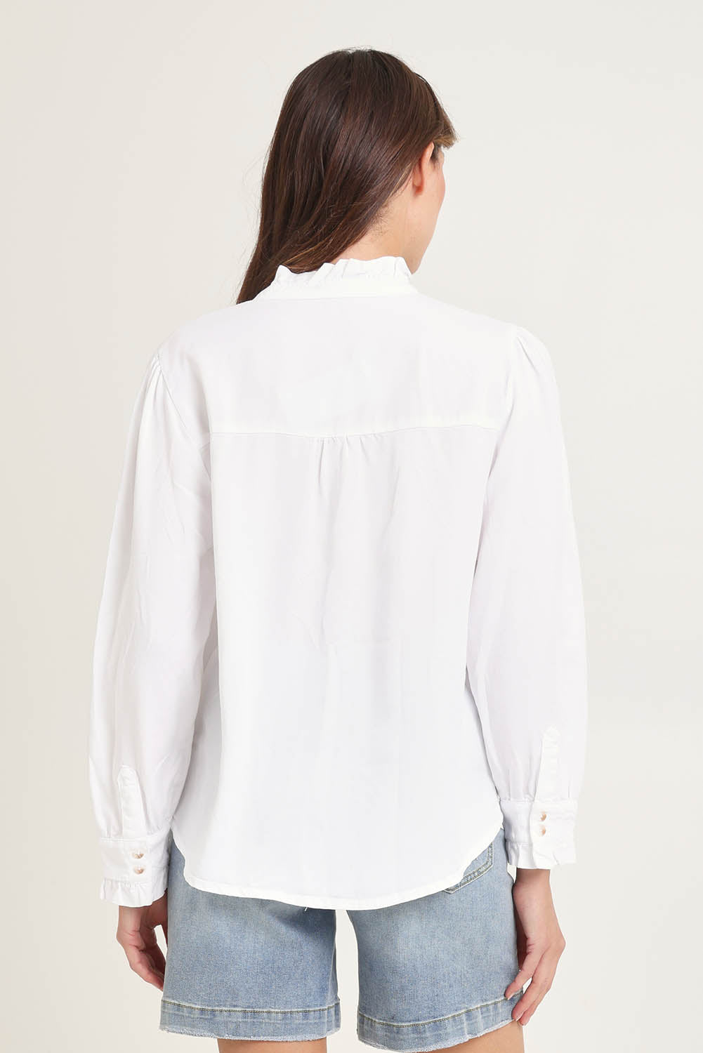 Model Madeline wearing size 10 of the Lucille Lyocell Pleated Shirt in colour White (White), from the back