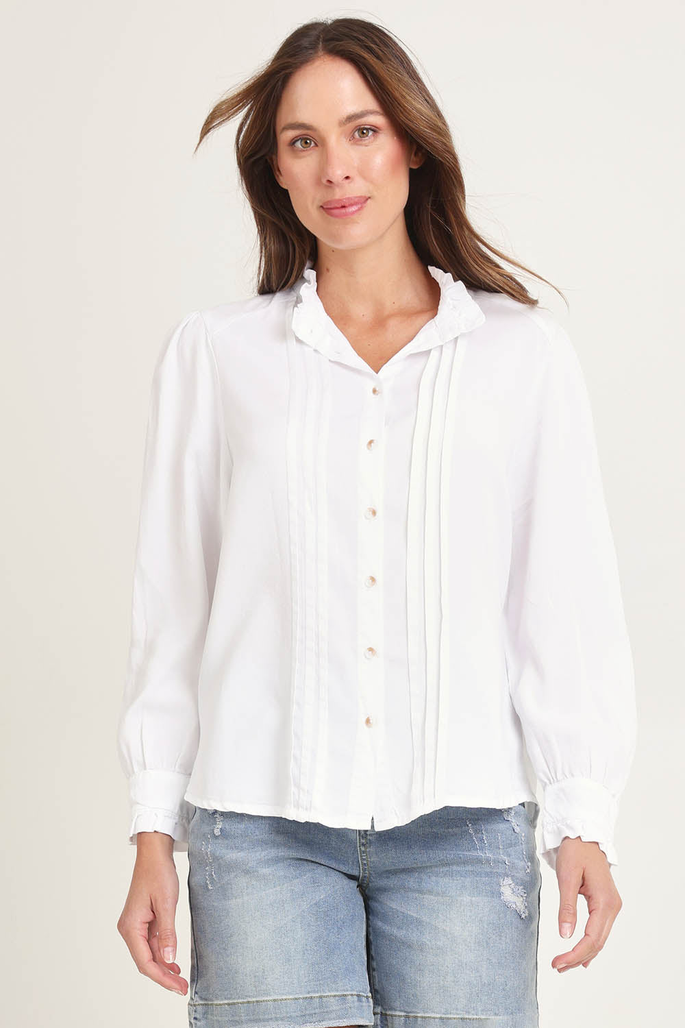 Model Madeline wearing size 10 of the Lucille Lyocell Pleated Shirt in colour White (White), from the front, cropped image