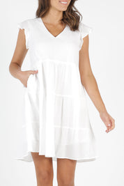 Model Madeline wearing size 10 of the Skyler Dress in colour White (White), from the front, cropped image