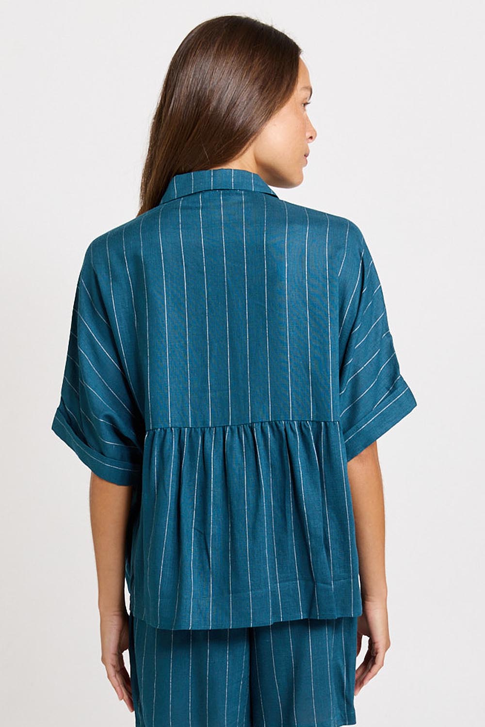 Model Genericm wearing size sample of the Ophelia Shirt – Teal in colour Teal, from the back