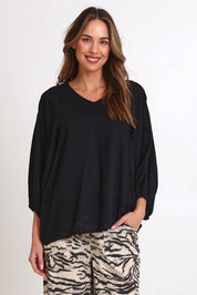 Model Madelinec wearing size 10 of the Bella Blouse – Black in colour Black, in a cropped view