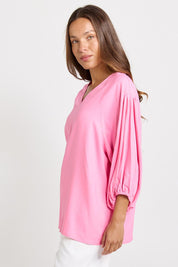Model Genericm wearing size sample of the Bella Blouse – Pink in colour Pink, from an angle
