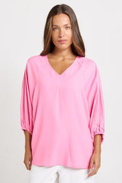 Model Genericm wearing size sample of the Bella Blouse – Pink in colour Pink, in a cropped view