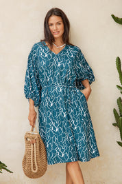 Model Genericm wearing size sample of the Bella Dress – Teal in colour Teal, from the front