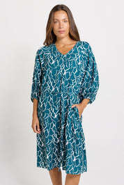 Model Genericm wearing size sample of the Bella Dress – Teal in colour Teal, from the front