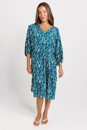 Model Genericm wearing size sample of the Bella Dress – Teal in colour Teal, from the front