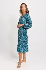 Model Genericm wearing size sample of the Bella Dress – Teal in colour Teal, from the front